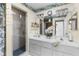 Bright bathroom with a double vanity, a walk-in shower, and stylish decor at 32537 Oak Park Dr, Leesburg, FL 34748