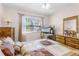 Bedroom with a window, warm decor, wooden furniture, and a ceiling fan at 32537 Oak Park Dr, Leesburg, FL 34748
