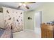 Bedroom with a decorated wall, closet, and desk, with an adjoining bathroom at 32537 Oak Park Dr, Leesburg, FL 34748