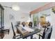 Dining area with dark wood furnishings, chandelier, and a sliding glass door at 32537 Oak Park Dr, Leesburg, FL 34748