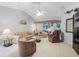 Spacious living room with high ceilings, plush furnishings, and ample natural light at 32537 Oak Park Dr, Leesburg, FL 34748