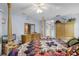 Well-lit main bedroom with a four poster bed, and a mirrored dresser at 32537 Oak Park Dr, Leesburg, FL 34748
