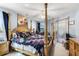 Spacious main bedroom with a four-poster bed, fan and sliding glass doors at 32537 Oak Park Dr, Leesburg, FL 34748