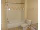Bathroom featuring tiled shower and bathtub combo with updated fixtures and a toilet at 3364 Westchester Square Blvd # 204, Orlando, FL 32835