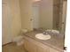Bathroom featuring a large mirror and vanity with a sink, as well as a toilet at 3364 Westchester Square Blvd # 204, Orlando, FL 32835