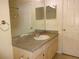 View of a bathroom with a vanity and large mirror, next to doorways on either side at 3364 Westchester Square Blvd # 204, Orlando, FL 32835