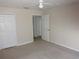 Bedroom with neutral carpeting, ceiling fan, and views of doorways and closets at 3364 Westchester Square Blvd # 204, Orlando, FL 32835