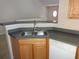 Practical kitchen with stainless-steel sink and faucet, plus gray countertops and ample cabinet space at 3364 Westchester Square Blvd # 204, Orlando, FL 32835