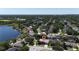 Aerial view of a lakeside community, highlighting lush greenery and scenic waterfront homes at 3436 Herringridge Dr, Orlando, FL 32812