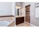 Well-lit bathroom featuring a shower, soaking tub, and dark wood vanity with light colored counters at 3436 Herringridge Dr, Orlando, FL 32812