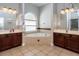 Bathroom with double vanity, soaking tub, and tile flooring at 3436 Herringridge Dr, Orlando, FL 32812