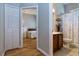 Bathroom and bedroom featuring wood floors, an updated shower and vanity, and lots of natural light at 3436 Herringridge Dr, Orlando, FL 32812