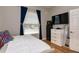 Bedroom featuring hardwood floors, tv, and natural light from the window at 3436 Herringridge Dr, Orlando, FL 32812