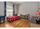 Well-lit bedroom with wood floors, themed curtains, and a Mickey Mouse bed at 3436 Herringridge Dr, Orlando, FL 32812