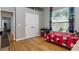 Bedroom with wood floors, a large window, and a red Mickey Mouse themed bed at 3436 Herringridge Dr, Orlando, FL 32812