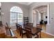Elegant dining room with a large window, wood floors, and a grand wooden table perfect for entertaining at 3436 Herringridge Dr, Orlando, FL 32812