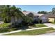 Well maintained exterior featuring lush landscaping and a brick driveway at 3436 Herringridge Dr, Orlando, FL 32812