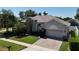 Home with a brick driveway, stone accents, and lush landscaping at 3436 Herringridge Dr, Orlando, FL 32812