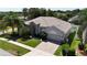 Well-maintained home with a paver driveway, a manicured lawn, and mature landscaping at 3436 Herringridge Dr, Orlando, FL 32812
