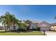 Charming single-story home with stone accents, manicured lawn, and lush landscaping, creating an inviting curb appeal at 3436 Herringridge Dr, Orlando, FL 32812
