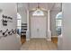 Bright foyer featuring tile flooring, a modern chandelier, and white columns, offering a grand entrance at 3436 Herringridge Dr, Orlando, FL 32812