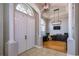 Stately foyer showcasing double doors, ceramic tile flooring, and a view of the office with light wood floors at 3436 Herringridge Dr, Orlando, FL 32812