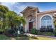 Inviting front entrance showcasing stone accents, a brick pathway, and lush tropical landscaping, creating a welcoming approach at 3436 Herringridge Dr, Orlando, FL 32812