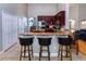 Kitchen with breakfast bar featuring dark wood cabinets, granite countertops, and stainless steel appliances at 3436 Herringridge Dr, Orlando, FL 32812