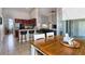 Open-concept kitchen and dining area with breakfast bar, modern table, and sliding glass door at 3436 Herringridge Dr, Orlando, FL 32812