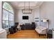 Bright office space featuring hardwood floors, a large window, modern lighting, and comfortable furnishings at 3436 Herringridge Dr, Orlando, FL 32812