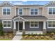 Charming two-story townhome featuring a welcoming front porch and well-maintained landscaping at 4244 Sadler Rd, Apopka, FL 32712