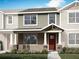 Charming townhome featuring stone accents, neutral siding, well-maintained landscaping, and a welcoming red front door at 4244 Sadler Rd, Apopka, FL 32712