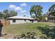 Spacious backyard featuring a well-maintained lawn, wooden fencing, and mature trees at 5163 Lighthouse Rd, Orlando, FL 32808