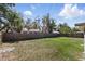 The backyard features a well-maintained lawn and a wooden privacy fence at 5163 Lighthouse Rd, Orlando, FL 32808