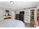 Bright bedroom with sliding barn door to bathroom, neutral walls, and wood-look flooring at 5163 Lighthouse Rd, Orlando, FL 32808