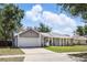 Charming single-Gathering home with attached garage, well-manicured lawn and inviting curb appeal at 5163 Lighthouse Rd, Orlando, FL 32808