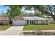 Charming home featuring a well-maintained front yard, driveway, garage, and a welcoming front door at 5163 Lighthouse Rd, Orlando, FL 32808