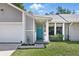 Close up of the home's entrance, featuring a blue door and lattice details at 5163 Lighthouse Rd, Orlando, FL 32808