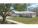 Charming single-story home with a gray exterior, white trim, and a well-maintained lawn at 5163 Lighthouse Rd, Orlando, FL 32808