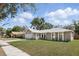Inviting single-Gathering home with a manicured lawn, attached garage, and charming front porch at 5163 Lighthouse Rd, Orlando, FL 32808