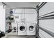 Laundry room features a sink, washer, dryer, and shelf for storage at 5163 Lighthouse Rd, Orlando, FL 32808