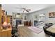 Cozy living room with brick fireplace, ceiling fan, and sliding glass doors to an outdoor area at 5163 Lighthouse Rd, Orlando, FL 32808