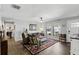 Sunlit living room featuring a ceiling fan, wood floors, and multiple windows at 5163 Lighthouse Rd, Orlando, FL 32808