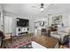 A cozy living room with wood floors and neutral walls is staged with chairs, TV and rugs at 5163 Lighthouse Rd, Orlando, FL 32808
