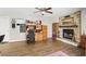 Living room with brick fireplace, hardwood floors, and door to the rest of the home at 5163 Lighthouse Rd, Orlando, FL 32808