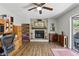 Comfortable living room featuring a brick fireplace, ceiling fan, and hardwood floors at 5163 Lighthouse Rd, Orlando, FL 32808