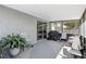 Enclosed patio with seating, a grill, and view of the backyard at 5163 Lighthouse Rd, Orlando, FL 32808