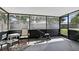 Enclosed patio with exercise equipment and outdoor seating, offering a view of the yard at 5163 Lighthouse Rd, Orlando, FL 32808