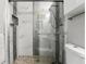 Updated bathroom shower with decorative tile, glass door, and new fixtures at 5163 Lighthouse Rd, Orlando, FL 32808
