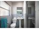 Clean bathroom with a pedestal sink, tiled shower, and ample natural light at 605 Oranole Rd, Maitland, FL 32751